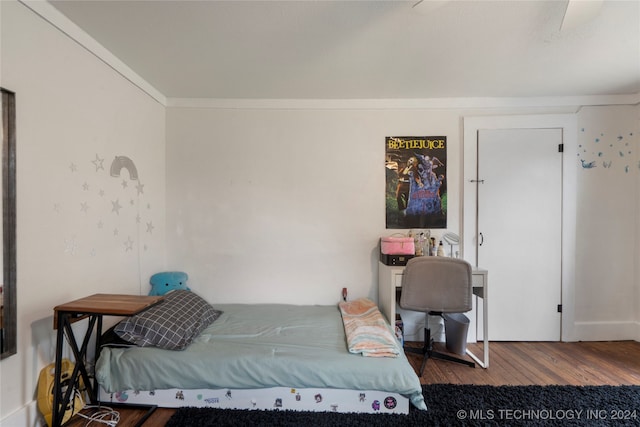 bedroom with crown molding, ceiling fan, and hardwood / wood-style flooring