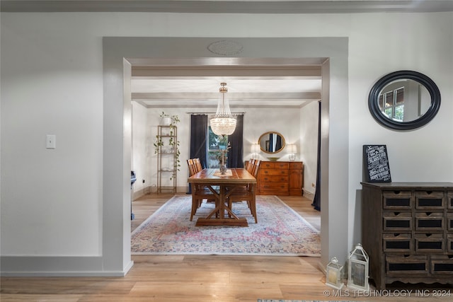 dining area featuring light hardwood / wood-style floors and a notable chandelier