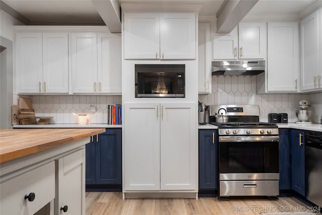 kitchen featuring blue cabinetry, appliances with stainless steel finishes, white cabinetry, and butcher block counters