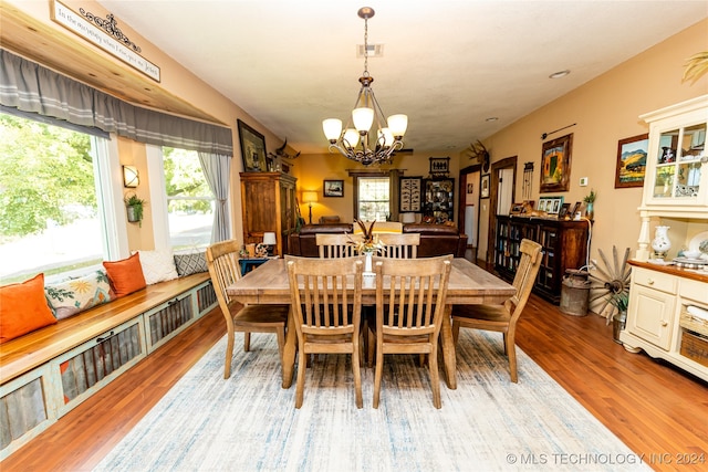 dining area featuring a notable chandelier and light hardwood / wood-style floors