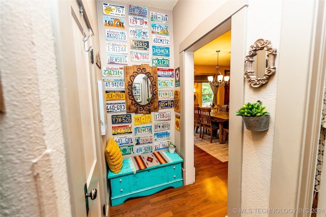 interior space with an inviting chandelier and hardwood / wood-style flooring