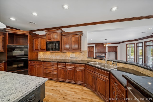 kitchen featuring backsplash, light wood-type flooring, black appliances, ceiling fan, and sink