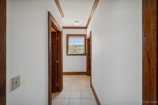 corridor featuring crown molding and light tile patterned flooring