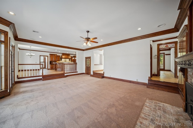 unfurnished living room with a brick fireplace, ceiling fan with notable chandelier, light carpet, and crown molding