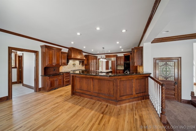 kitchen featuring custom range hood, backsplash, pendant lighting, and light hardwood / wood-style flooring