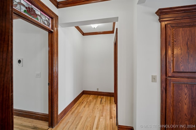 hall featuring crown molding and light hardwood / wood-style floors