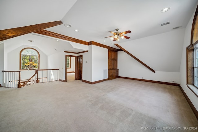 carpeted spare room with ornamental molding, vaulted ceiling, and ceiling fan