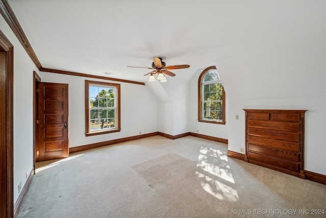 bonus room with ceiling fan, light colored carpet, and plenty of natural light