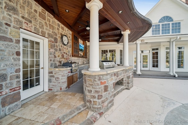 view of patio / terrace featuring area for grilling, ceiling fan, and exterior kitchen