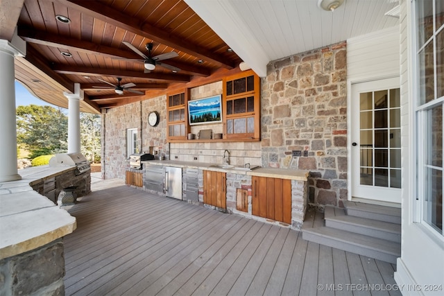 wooden terrace featuring area for grilling, ceiling fan, and sink