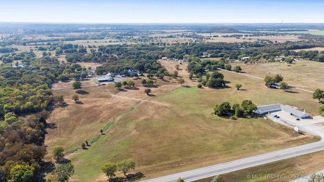 birds eye view of property with a rural view