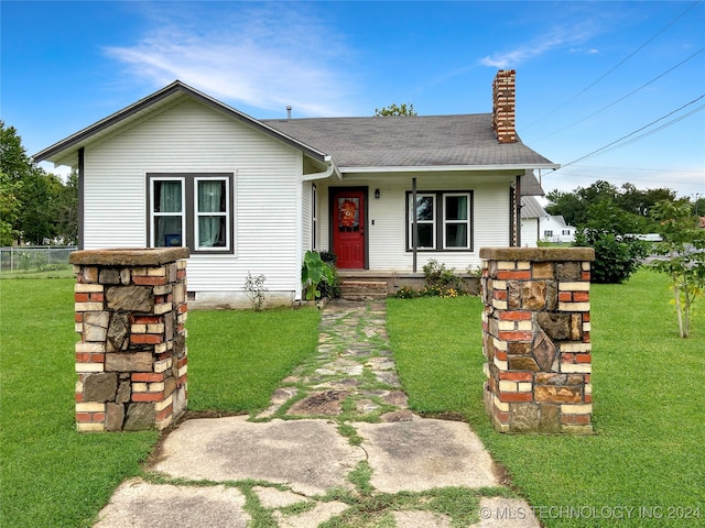 bungalow-style home with a front yard