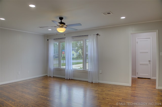 unfurnished room featuring dark hardwood / wood-style floors, ceiling fan, and ornamental molding