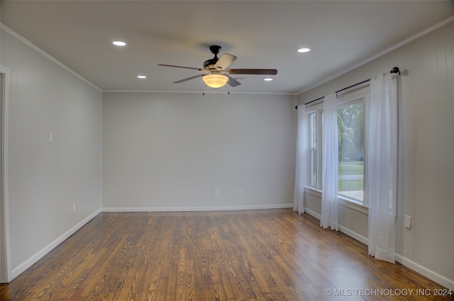 empty room featuring ceiling fan, crown molding, a healthy amount of sunlight, and dark hardwood / wood-style floors