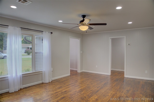 spare room featuring dark hardwood / wood-style floors, ceiling fan, and ornamental molding