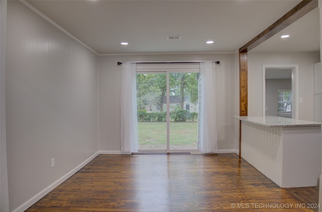 interior space with crown molding and dark wood-type flooring