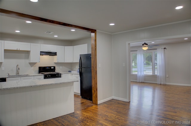 kitchen with black appliances, dark hardwood / wood-style flooring, white cabinets, and sink