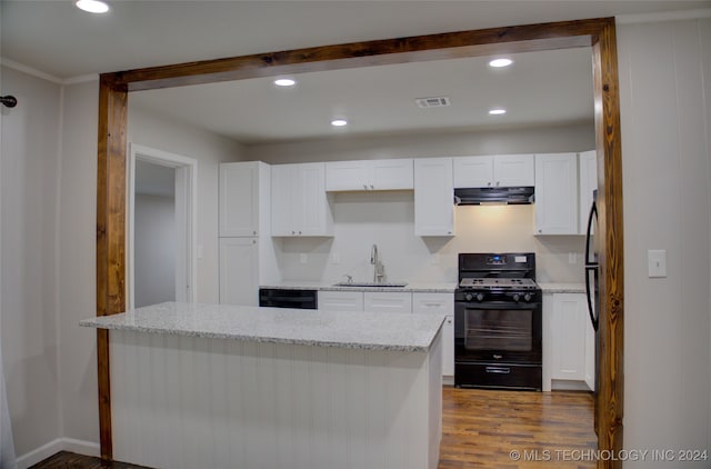 kitchen with sink, light hardwood / wood-style floors, white cabinetry, and black appliances