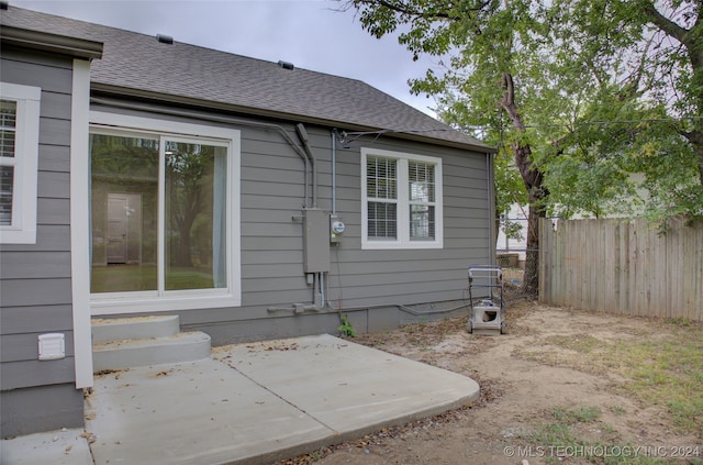 view of side of home with a patio area