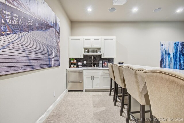 home office with light carpet and indoor wet bar