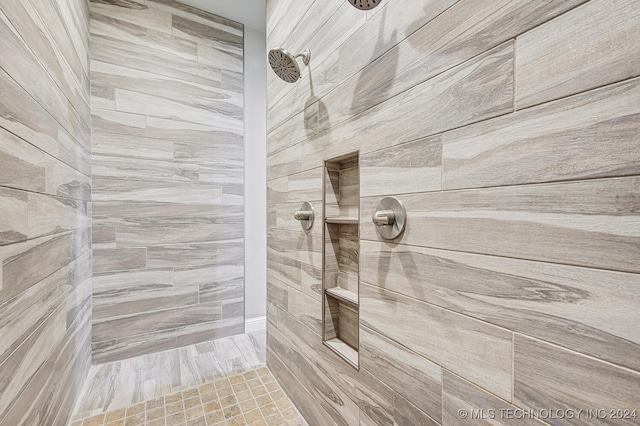 bathroom with tiled shower