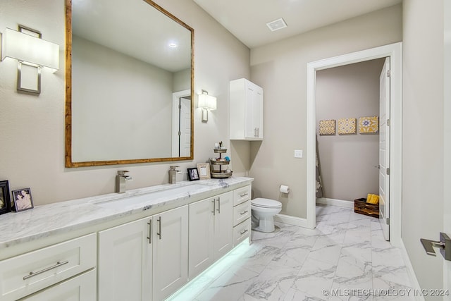 bathroom featuring vanity and toilet