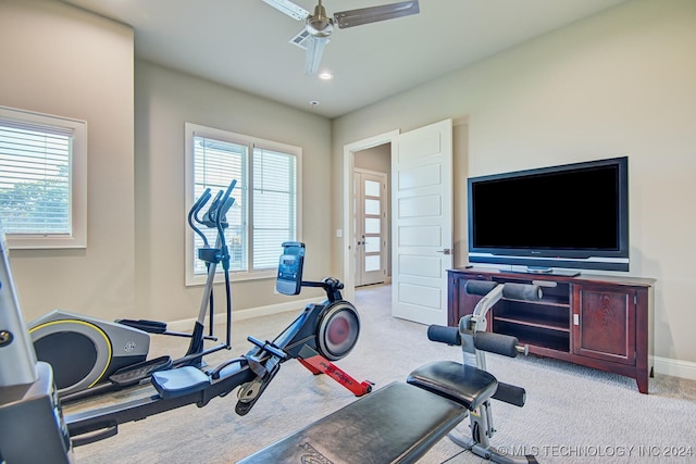 exercise room featuring ceiling fan and light colored carpet