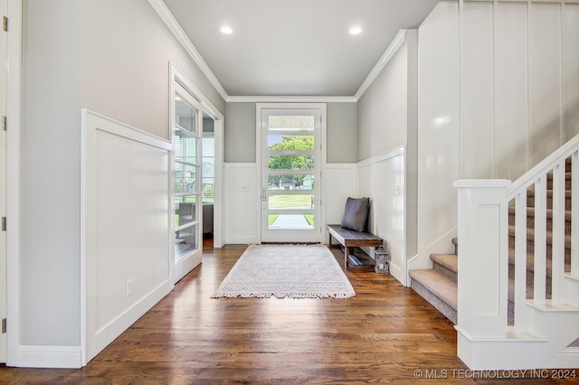 entryway with crown molding and dark hardwood / wood-style flooring