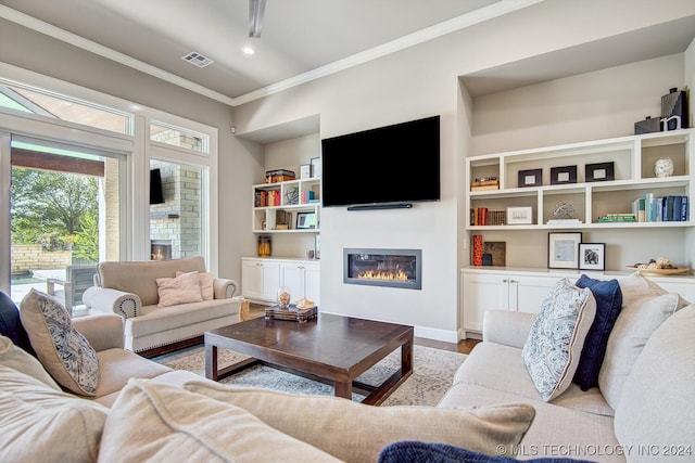 living room with light wood-type flooring and crown molding