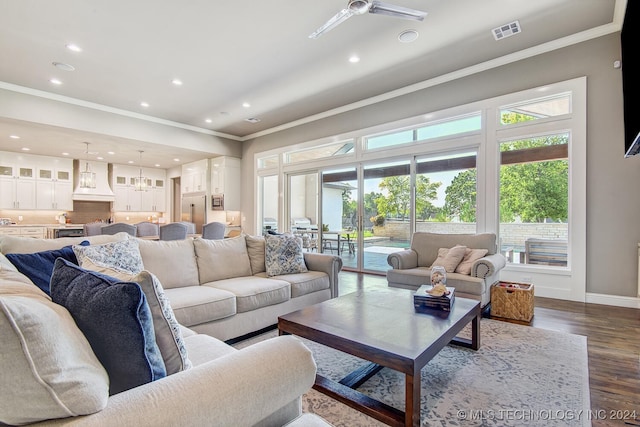 living room with ornamental molding, ceiling fan, and hardwood / wood-style flooring