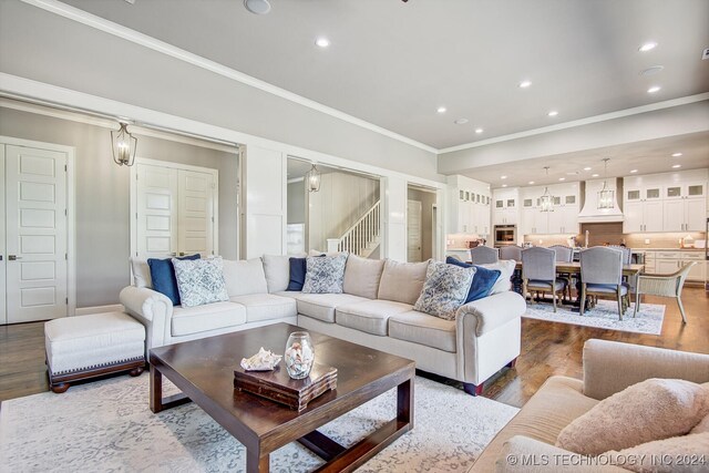 living room featuring ornamental molding and hardwood / wood-style floors