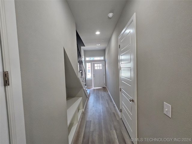 hallway with hardwood / wood-style flooring