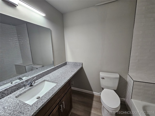 full bathroom featuring vanity, plus walk in shower, hardwood / wood-style floors, and toilet