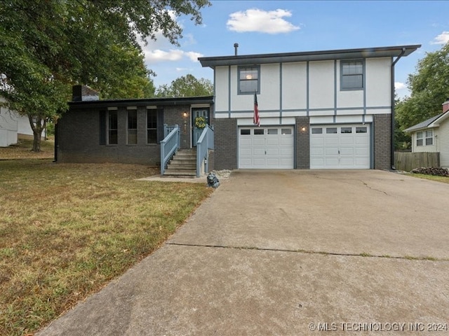 view of front of house with a front yard and a garage