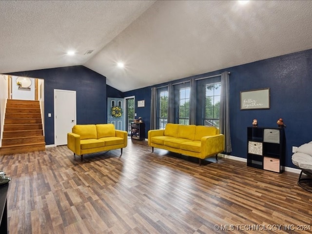 living room featuring a textured ceiling, vaulted ceiling, and dark hardwood / wood-style floors