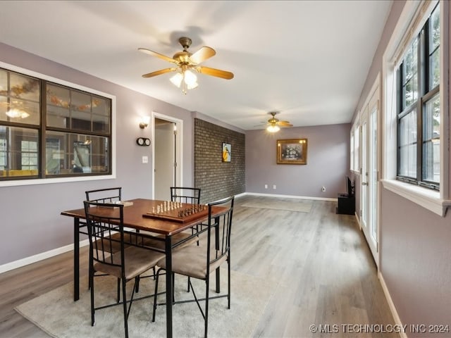 dining area with ceiling fan, hardwood / wood-style flooring, and a wealth of natural light