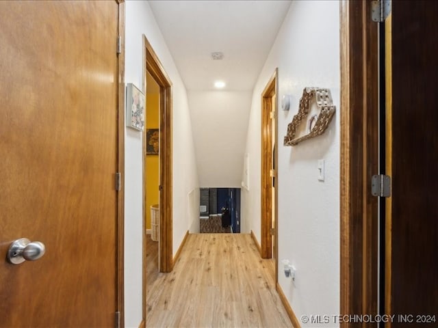 corridor with light hardwood / wood-style floors