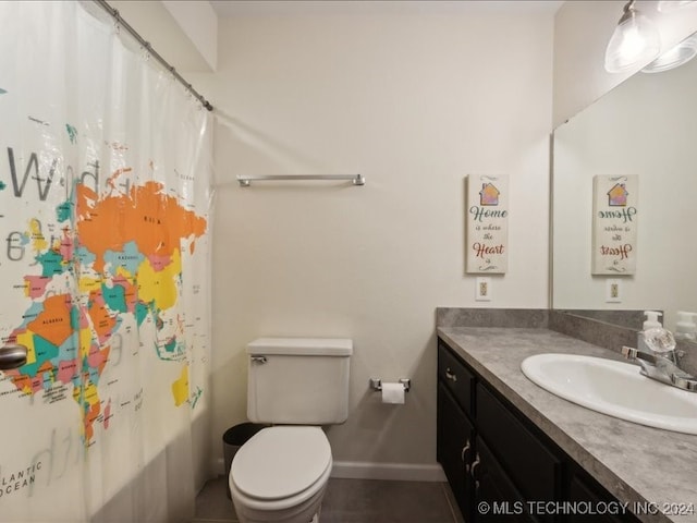 bathroom with vanity, toilet, and tile patterned floors