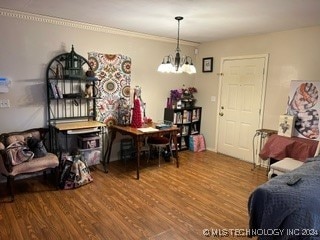 dining room with hardwood / wood-style floors and a notable chandelier