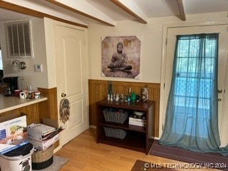 interior space with beamed ceiling and light hardwood / wood-style floors