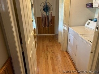 washroom featuring washer and clothes dryer and light hardwood / wood-style floors