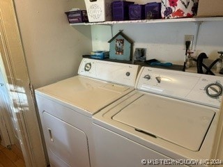 clothes washing area featuring separate washer and dryer