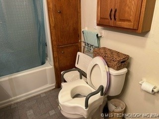 bathroom with shower / tub combo and toilet