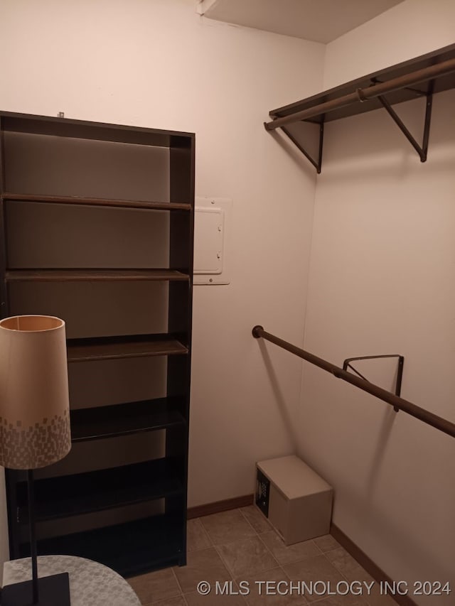 walk in closet with light tile patterned floors