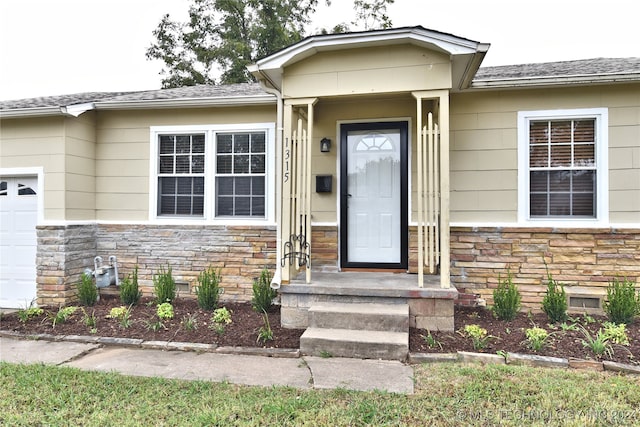 view of exterior entry featuring a garage