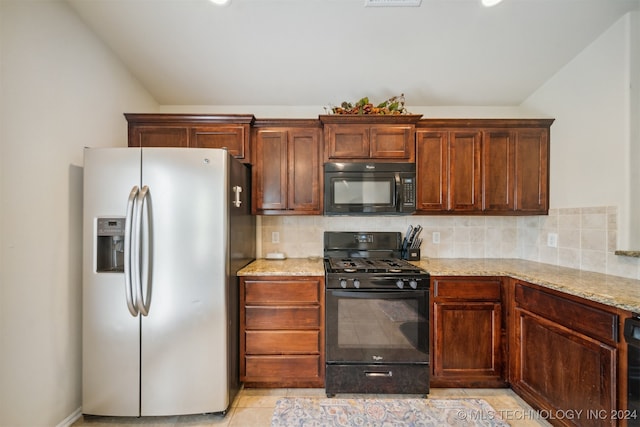 kitchen featuring black appliances, light tile patterned flooring, backsplash, and light stone counters