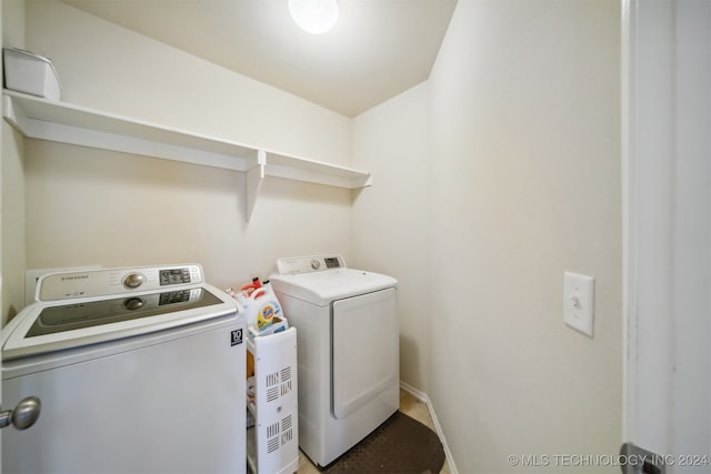 washroom with washing machine and clothes dryer