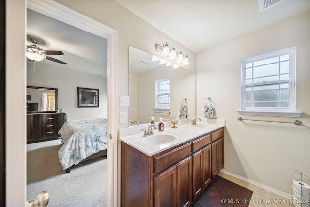 bathroom featuring ceiling fan, vanity, and a wealth of natural light