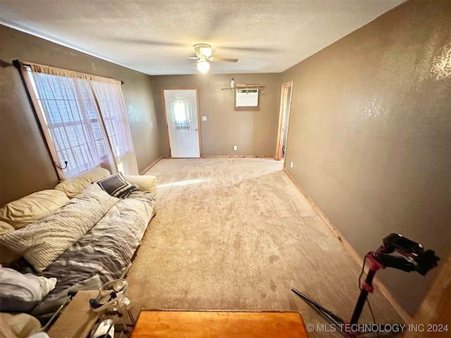 living room featuring a textured ceiling, carpet, ceiling fan, and a wall mounted air conditioner