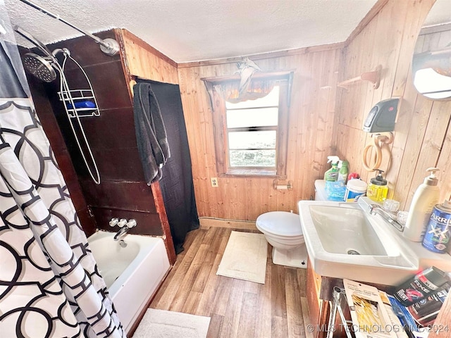 full bathroom featuring toilet, wooden walls, hardwood / wood-style floors, and shower / bathtub combination with curtain